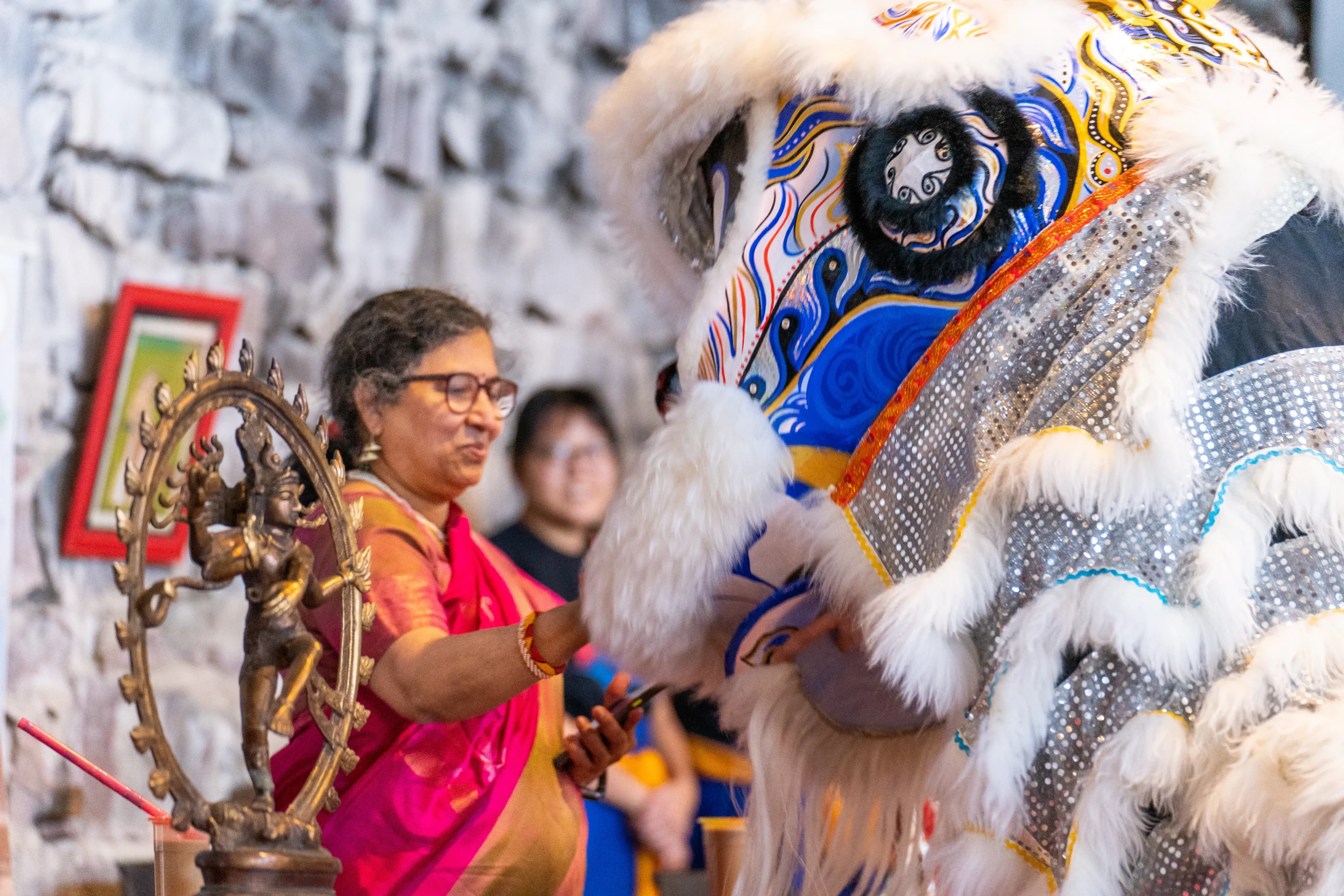 Lion Dancer interacting with Indian woman